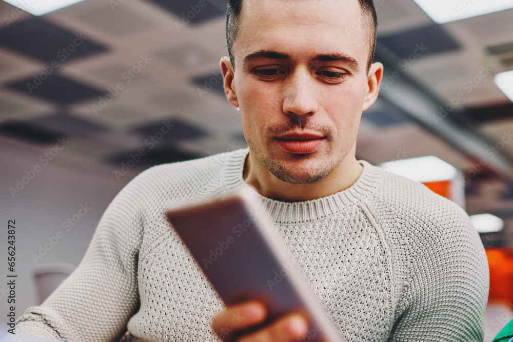 Poster hipster guy reading email with notification on digital cellular using 4g internet connection