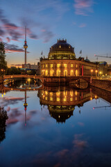 The Bode-Museum and the Television Tower reflected in the river Spree in Berlin at dawn