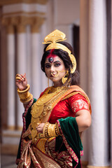 Beautiful young woman dressed as Hindu goddess Durga , She is wearing Banarasi Saree and heavy gold Jewellery. Traditional Dancer dressed as Devi Durga.