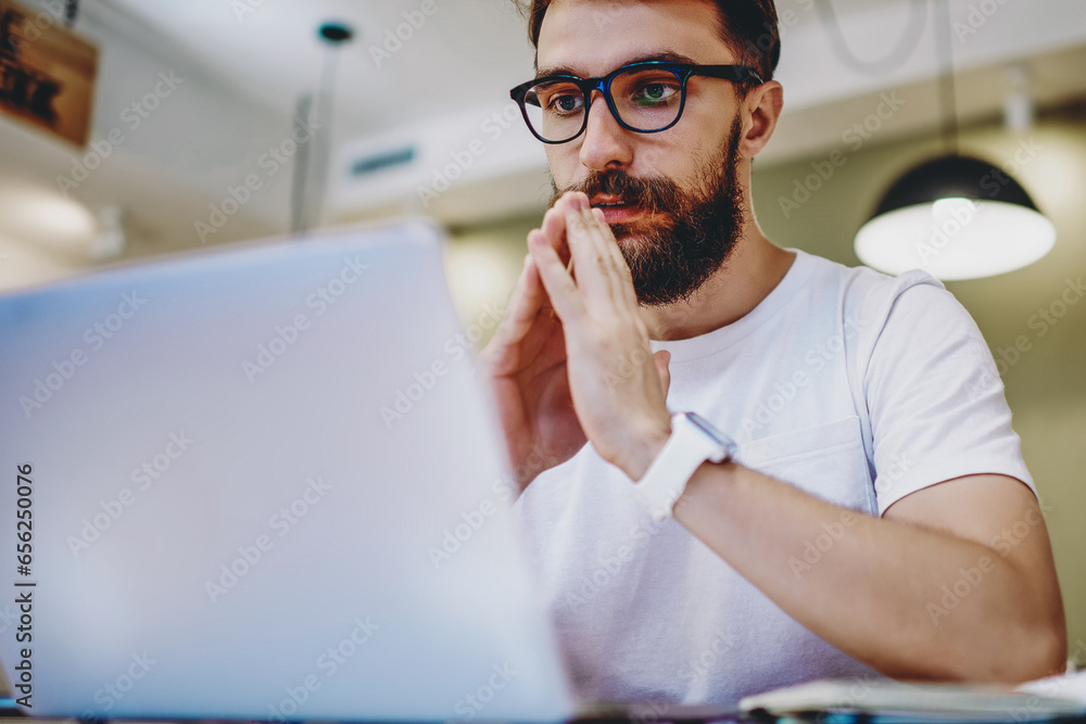 Poster skilled pensive programmer updating antivirus software on netbook waiting for loading