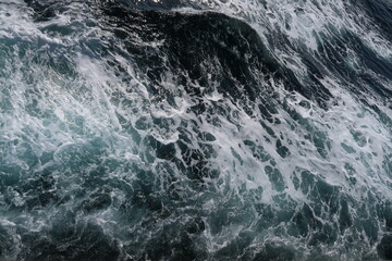 white sea foam on dark blue sea, splash, waves of the ocean