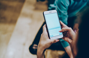 female's hand holding mobile phone for share publication in personal blog via 4G connection