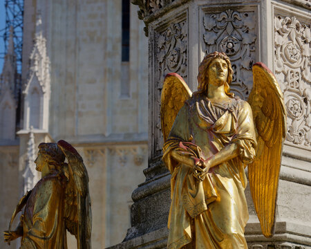Selective focus photo of an Angel statue placed on a column in front of Zagreb Cathedral, Croatia