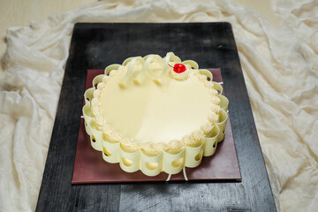 Vanilla Cake include cream, sugar, red berry served on board isolated on napkin side view of cafe food