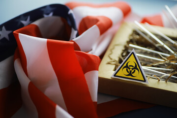 American flag and biohazard sign. The concept of American biolabs and research centers.
