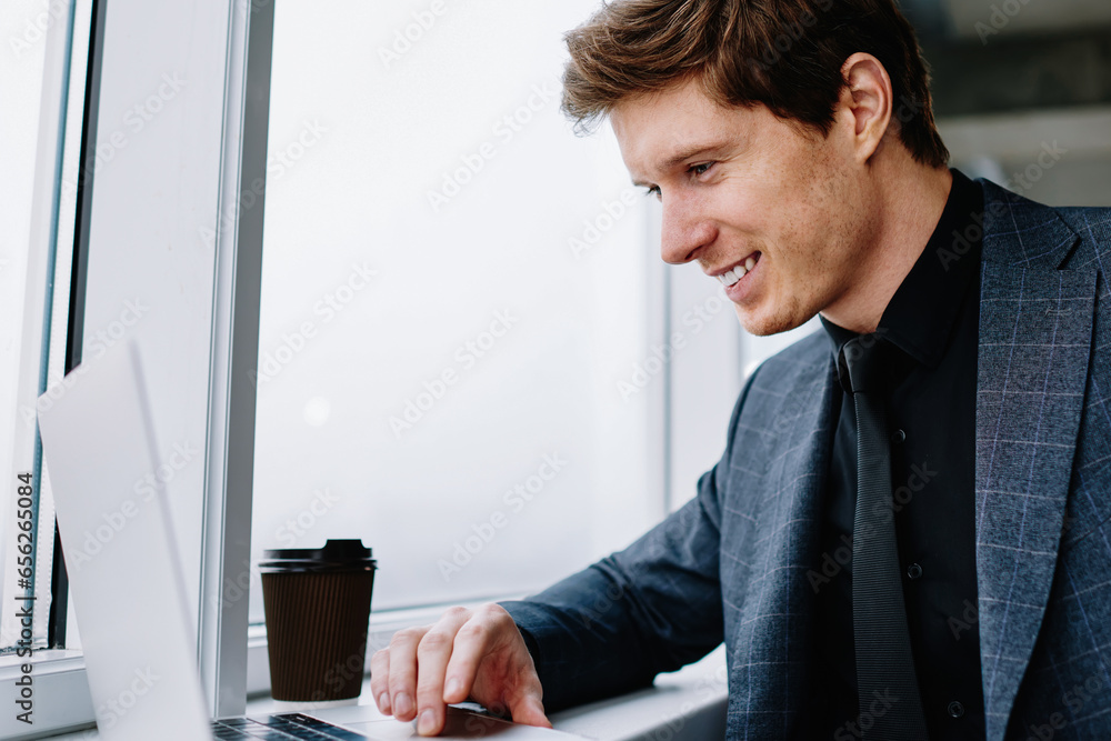 Poster happy businessman get useful information for startup from website on netbook sitting in office