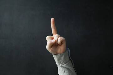 Male hands on a gray background. Finger gestures. Gesticulation with hands.