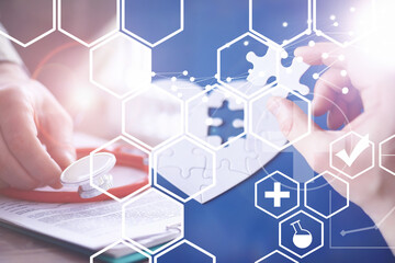 Stethoscope, puzzle heart, prescriptions. Double exposure in composition. Doctor`s desk in the clinic's office.