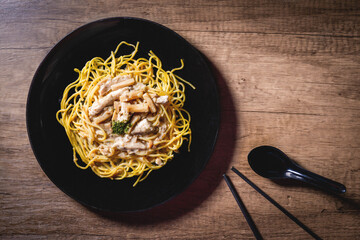Spaghetti Pasta with Chicken Breast, Cream and Truffle Cheese brown wooden table Copy space, top view