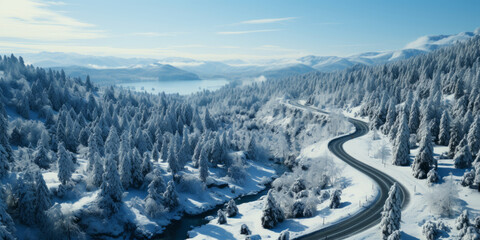 Aerial view of a winter snow-covered road with Serpentine Switchbacks in a forest.