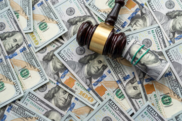 New 100 dollar paper money pile with judges gavel. Lot of dollars close up - Powered by Adobe