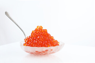 Red caviar.Transparent dishes in the form of shell. Useful omega. Copy space. Isolated object.