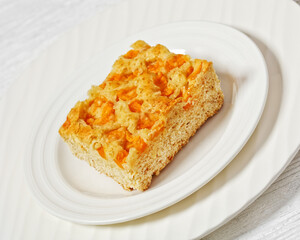 peach cake on white plate, top view