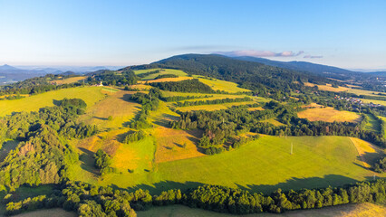 Green hilly landscape with green meadows and forests. Jested ridge near Liberec, Czechia. Aerial view from drone.