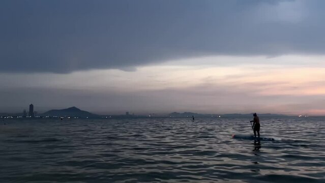 Silhouett of  Paddleboarder.  Recreation Paddling Sup Surfboard in the sean while sunset.