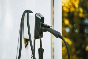 Electric Vehicle charger station on wall. Energy EV car concept. Futuristic hybrid vehicle charge battery