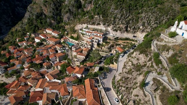 Old Church Overlooking Dhermi: Aerial View of Mediterranean Village with Red Roofs, Stone Walls, and Narrow Alleys, a Tourist Hotspot