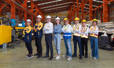 Industrial teamwork. Group of male and female factory labor stand smiling together with arms...