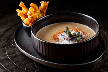 mushroom cream soup in bowlon wooden background