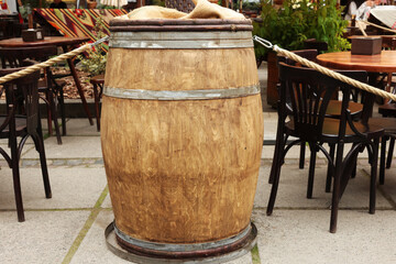 Traditional wooden barrel near street cafe outdoors