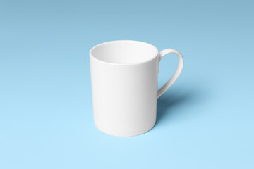 White ceramic mug on light blue background