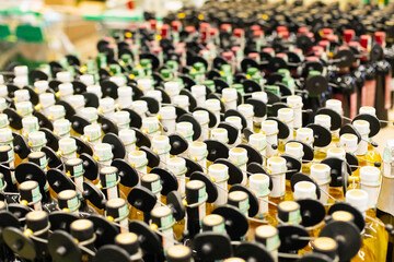 Obraz premium Alcohol drink bottles a lot, RFID hard tag, shoplifting anti-theft security sensor. Wholesale store, supermarket.