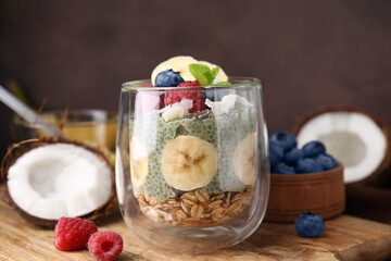 Tasty oatmeal with chia matcha pudding and fruits on wooden board, closeup. Healthy breakfast