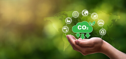 CO2 emission reduction concept, Environmental icons, global warming and renewable energy in hand on...
