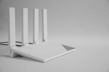 Modern Wi-Fi router on light grey background. Space for text