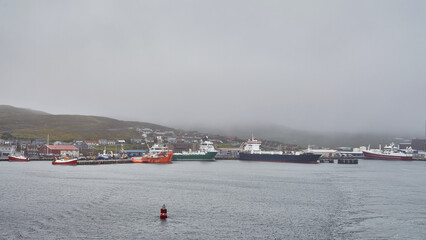 Fototapeta na wymiar Lerwick city harbor on the shetland island with different vessels inside.