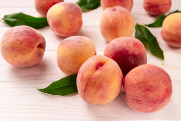 Fresh peaches on a wooden table.