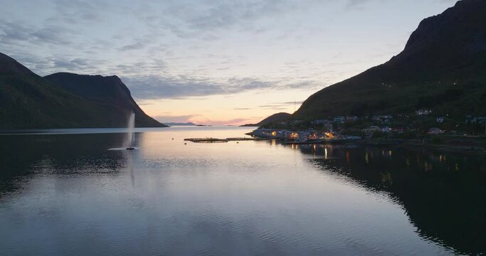 Cinematic aerial footage of the sunset and the town Torsken in the background, Norway, Europe