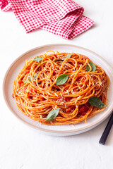 Spaghetti pasta with tomato sauce, basil and Parmesan cheese. Italian cuisine. Vegetarian food.