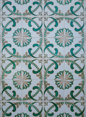 Part of a typical Portuguese wall decorated with tiles. Beautiful white, green and gold colors. Portugal. Vertical photo.