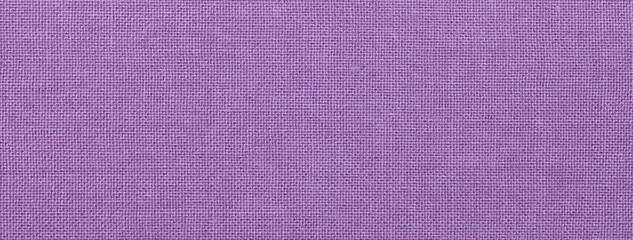 Texture of violet color background from textile material with wicker pattern, macro. Vintage lavender fabric