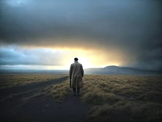 Foto op Plexiglas A man walking in a field alone © Roshan