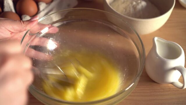 Woman prepares dough for pancakes. Mixing baking ingredients. Cooking, preparing breakfast, dessert