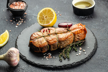 Cooked salmon steak with herbs, lemon, olive oil, Grilled fresh fish for healthy dinner, Restaurant...