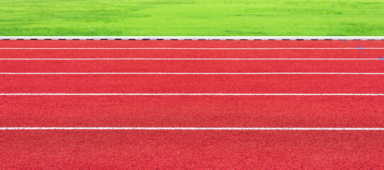 Horizontal image of red running track in an outdoor sports stadium. For sports athletics or exercise