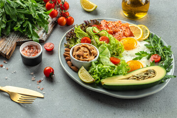 Healthy eating food vegetables salad, avocado, fish, eggs, nuts peanut paste. low carb keto...