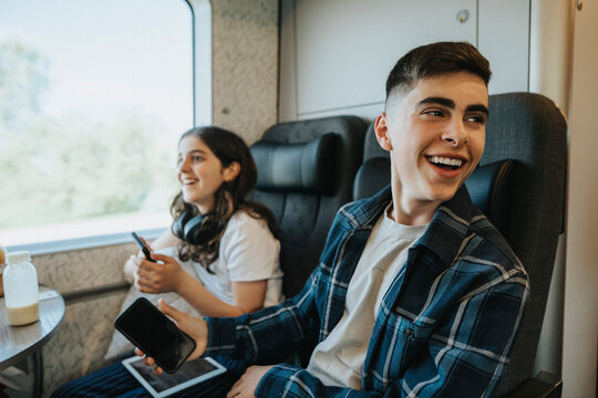 Happy siblings having fun while traveling in train