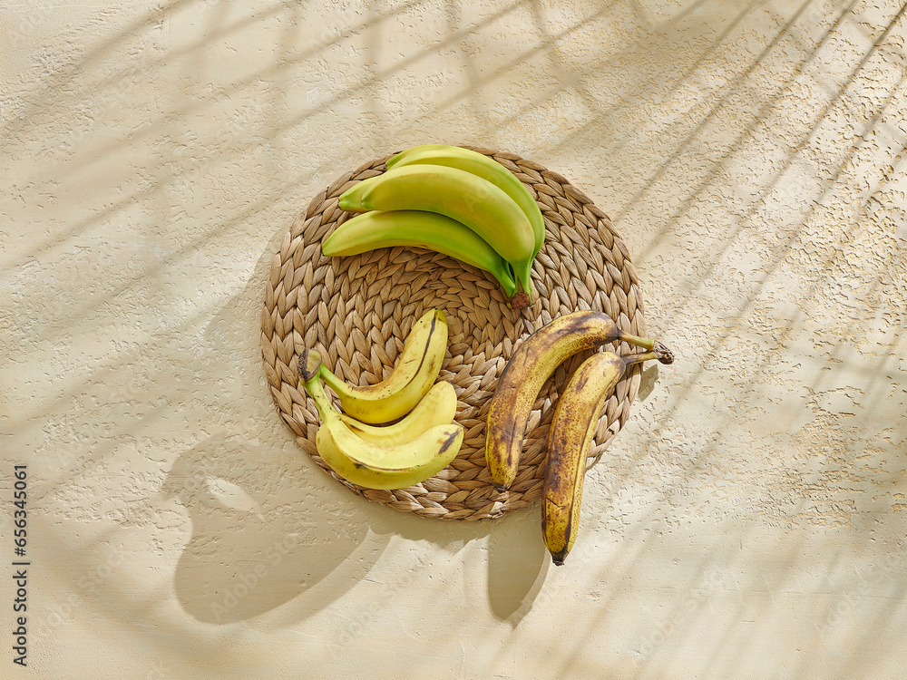 Wall mural banana is on the wooden table, healthy lifestyle, yellow and green.