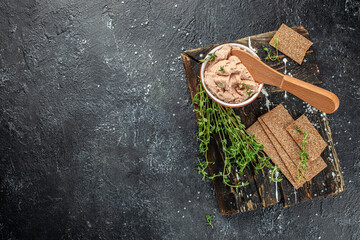 The bowl of pate on a dark background. Traditional French meat appetizer. banner, menu, recipe place for text, top view