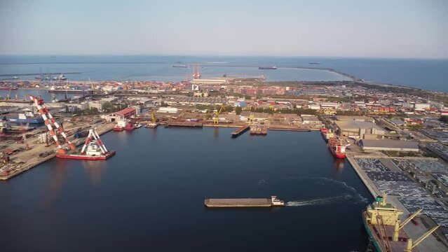 Panoramic aerial view of the Constanta port in Romania. 4k Drone flyover shot of ships and platforms operating at a sea port.
