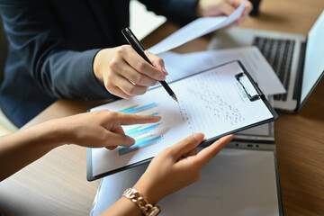 Cropped shot of businesspeople analyzing statistics, financial results at meeting table