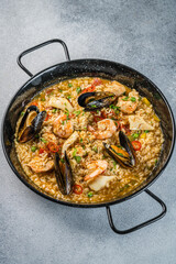 Italian Cuisine. Greek seafood and rice paella with shrimp, mussels and squid. on a light background. View from above