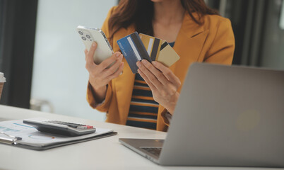 Women holding credit card and using smartphones at home.Online shopping, internet banking, store...