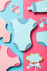Paper baby things on blue and pink background, top view