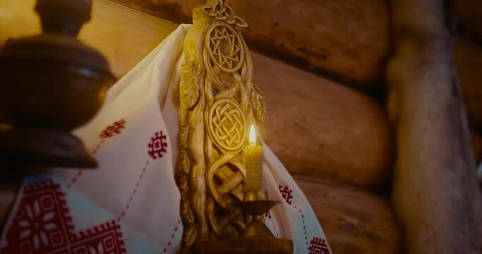 interior of old wooden house in village of early Slavs, burning candle on wall, closeup, 4K, Prores