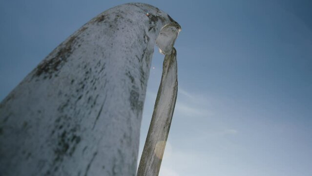 Tilt up from winterized boat to Whale Bones arch at Utqiagvik Barrow Alaska North Slope in the Arctic